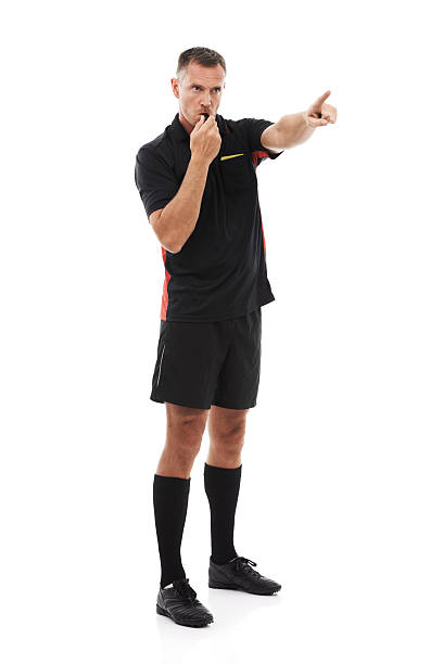 Bring the ball there! A referee blowing his whistle and pointing isolated against a white background referee stock pictures, royalty-free photos & images
