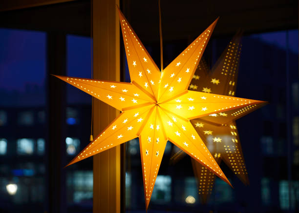 istock Decorative Christmas star on a window on a winter evening during the Christmas holidays 1870710896
