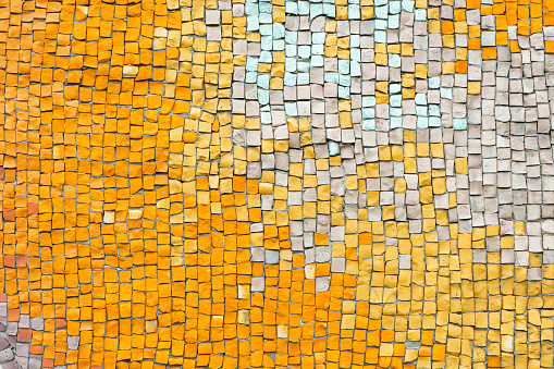 Abstract mosaic ceramic tile background. Chaotic pattern of orange and white ceramic tiles, wall decor, interior design element. Wallpaper, backdrop, copy space.
