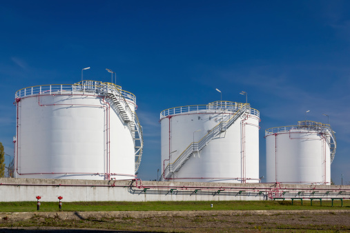 Oil storage tanks under blue sky