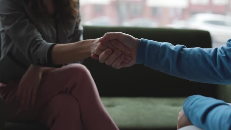 Couple signing a document. Hand shaking after a deal