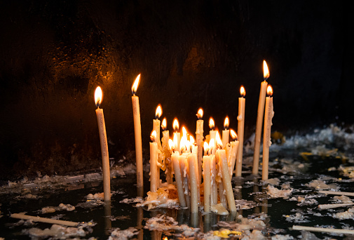 Church candles burn in the church