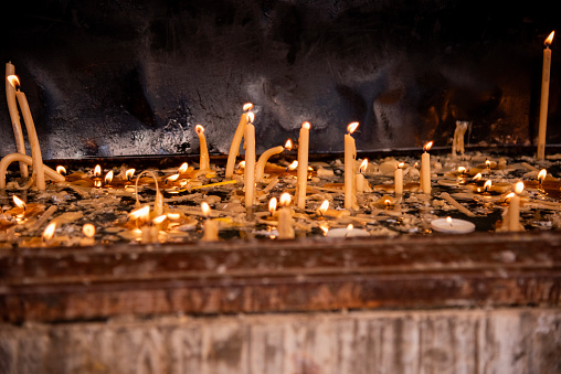 Church candles burn in the church