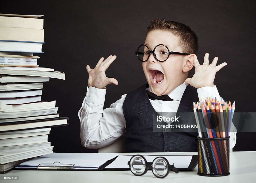 professor of child Young boy doing homework Book Stock Photo