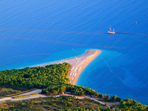 The Golden Cape (Zlatni rat) beach on island Brac, Croatia. It is triangle of shingle that changes shape with the winds and tides with perfect azure sea. It is surfing meca.