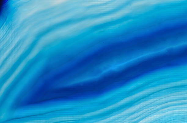 Closeup of blue banded agate mineral stone, pattern background with details of mineralogy