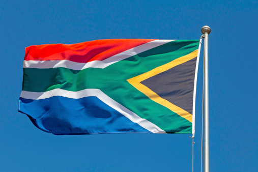 South African flag on a flag pole, in the wind.