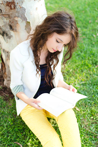 istock Teenage girl reading book 187078151
