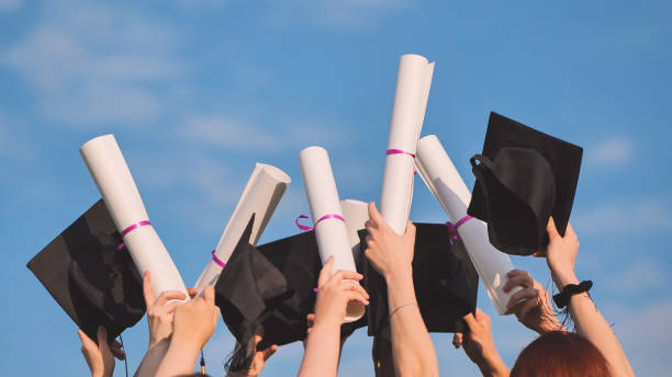 istock Graduates connect diplomas and caps on a sunny day. 1870781674