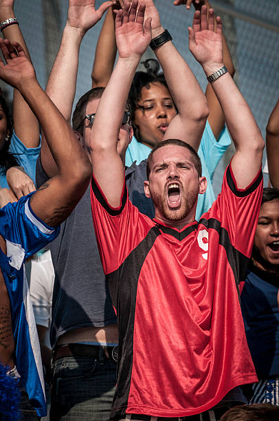 istock Fans with raised arms cheering for their team 187078302