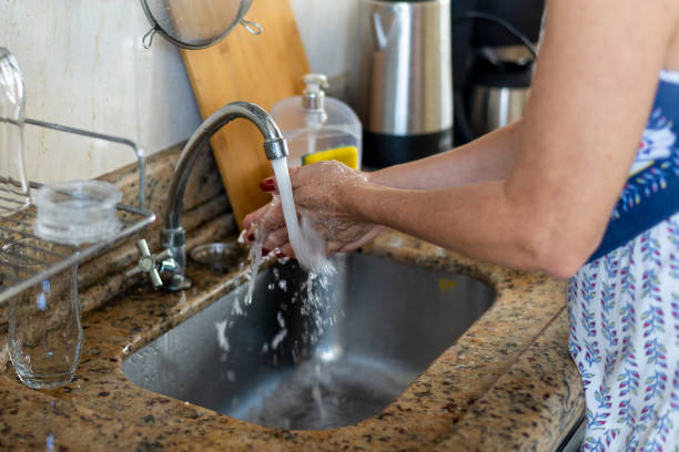 istock Cook washing her hands to cook. 1870785024