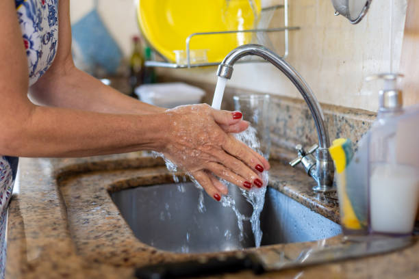 istock Cook washing her hands to cook. 1870785321