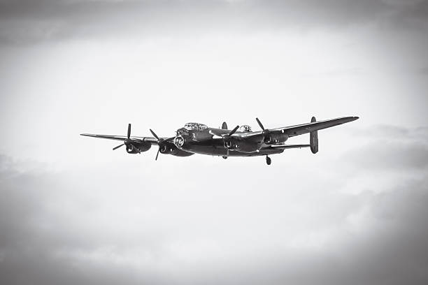 RAF Lancaster Bomber PA474 flying in mid air over Flevoland during the 2022 4th of May memorial day in The Netherlands. The Avro Lancaster heavy bomber is operated by the Royal Air Force Battle of Britain Memorial Flight and is making a tribute to all members of Bomber Command shot down over The Netherlands.