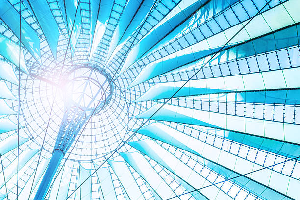 An upward view of the impressive glass and steel dome of the Center Potsdamer Platz (formerly known as the Sony Center) in Berlin, Germany. The architectural structure, inspired by Mount Fuji, features radial steel beams and translucent fabric panels that create a striking modern canopy over the central plaza.