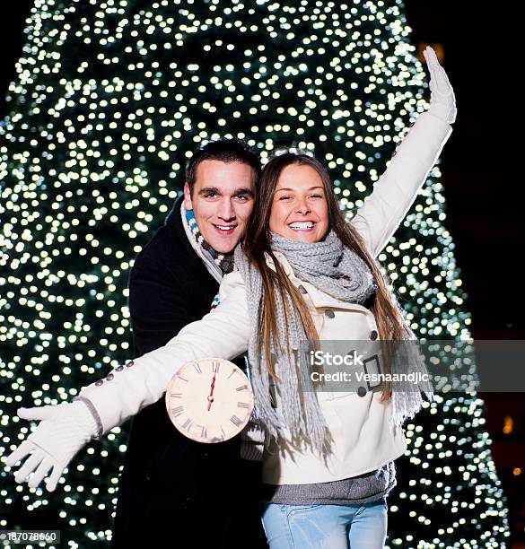 New Years Eve Outside Stock Photo - Download Image Now - Celebration, Young Couple, 12 O'Clock