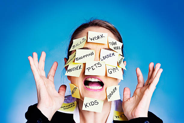 istock I give up! Overwhelmed woman covered in  task reminders 187081678