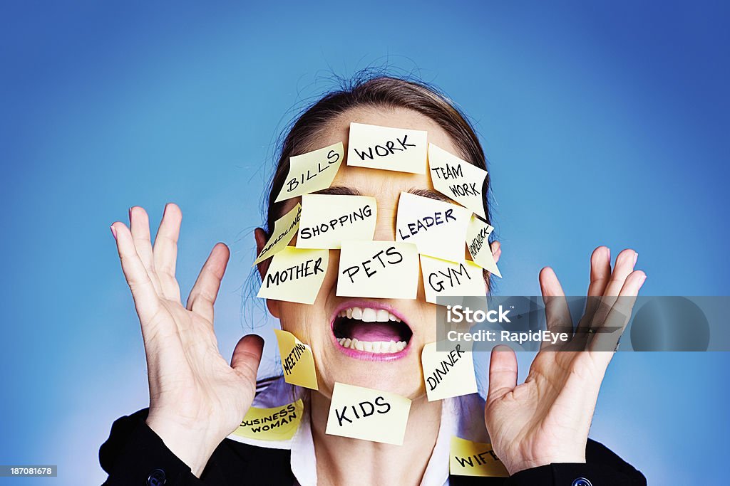 I give up! Overwhelmed woman covered in  task reminders An overworked and overwhelmed woman covered in post-it reminders of tasks surrenders, raising her hands and yelling hysterically. She's seriously over committed and can't cope with this much multitasking! Multi-Tasking Stock Photo