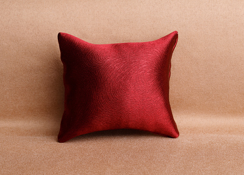 Red luxury silk pillow on a sofa