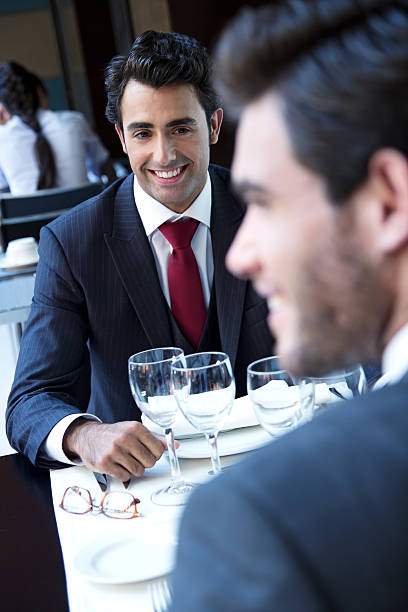 istock Two smiling business men have dinner at restaurant 187081893