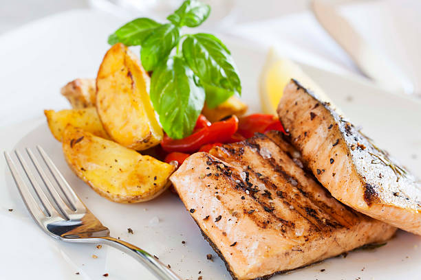 istock Grilled salmon filet with baked potatoes 187082426