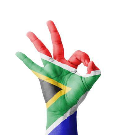 Hand making Ok sign, South Africa flag painted as symbol of best quality, positivity and success - isolated on white background