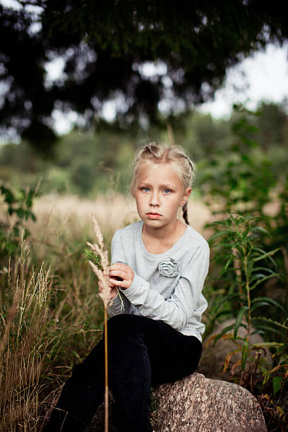 istock alone girl sitting on the stone 187083409