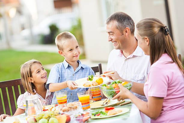 istock Family enjoying an outside summer lunch 187084303