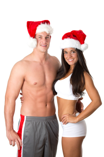 fit couple wearing santa hat as fitness for christmas concept