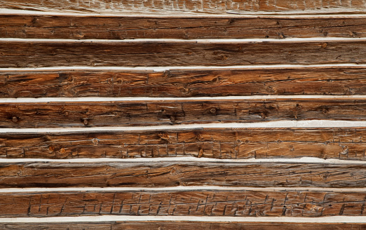 Close-up of an old log wall with white chinking. Montana. Great for backgrounds.