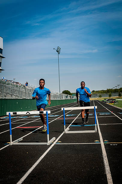 istock Young hurdle runners compete at the high scool race (II) 187085921