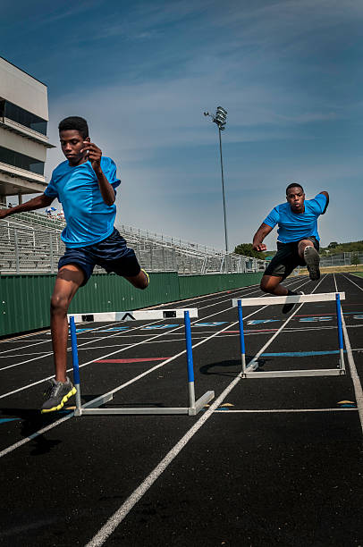istock Young hurdle runners compete at the high scool race (I) 187085924