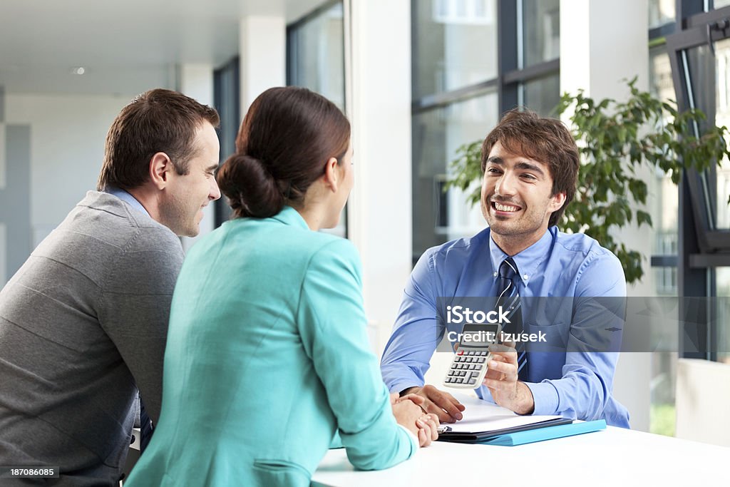 Business consulting Adult couple having meeting with business consultant.  Real Estate Stock Photo