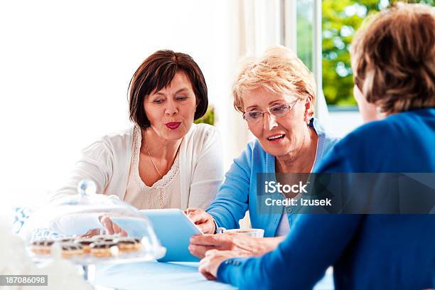 Mature Women Using Digital Tablet Stock Photo - Download Image Now - Lifestyles, Senior Adult, Adult