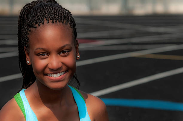 istock Young female track competitor relaxing - VI 187086599