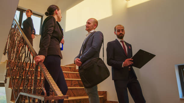 istock Coworkers standing on stairs talking 1870869188