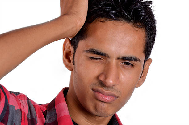 istock Confused Young Man Scratches His Head 187087012