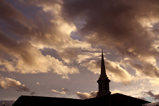 istock Church Steeple Silhouetted Against Sunset Clouds 187087048