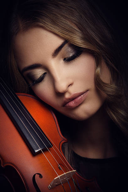 istock young woman with her violin 187087222