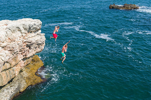 istock jumping into the sea 187087289
