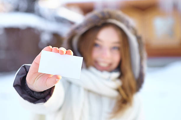 istock Young beautiful woman with blank visiting card. Winter. 187087517