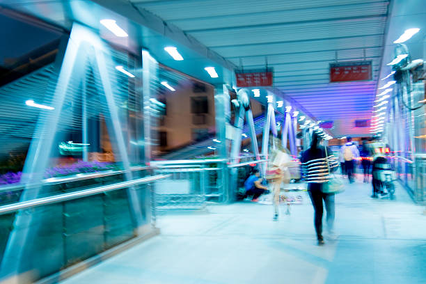 Blurred motion of a young man walking in front of illuminated stairs in Kyoto, Japan. Nikon D800.
