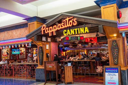 Dallas, USA - June 17, 2023. Passengers dining inside Pappasito's Cantina restaurant at the terminal of Dallas Fort Worth International Airport, Dallas, Yexas , USA