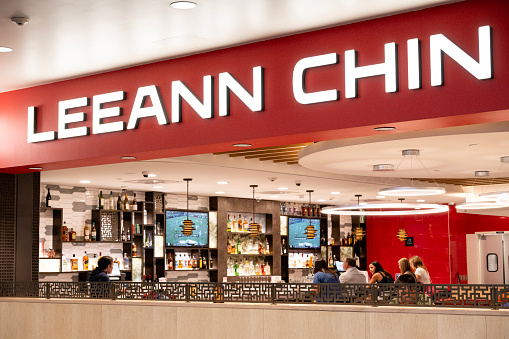 Minneapolis, USA - June 10, 2023. Travelers dining inside Leeann Chin restaurant at the terminal of Minneapolis St Paul International Airport, Minnesota, USA