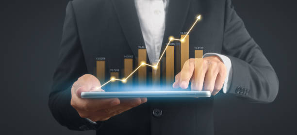 istock Businessman plan graph growth and increase of chart positive indicators,tablet in hand 1870883487