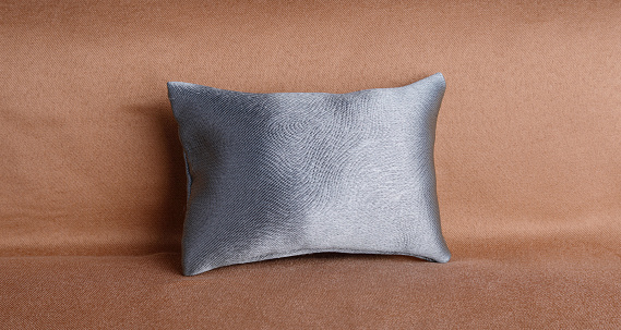Silk pillow on beige background