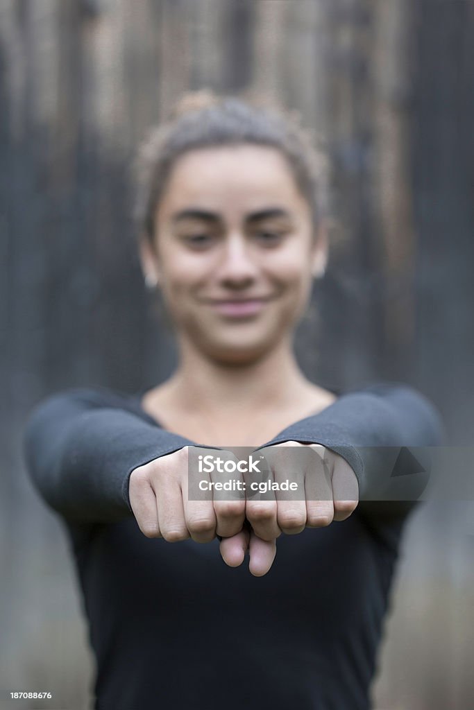 Happy Teenage Girl Smiling teenager with extended fists 14-15 Years Stock Photo