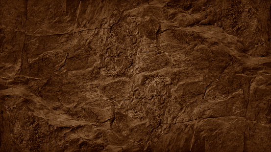 Dark orange rust brown stone texture background. Rough rock mountain surface. Nature. Close-up. Vein cracks. Empty space. Design.
