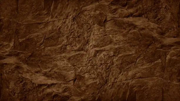 Photo of Dark orange rust brown stone texture background. Rough rock mountain surface. Nature. Close-up. Vein cracks.