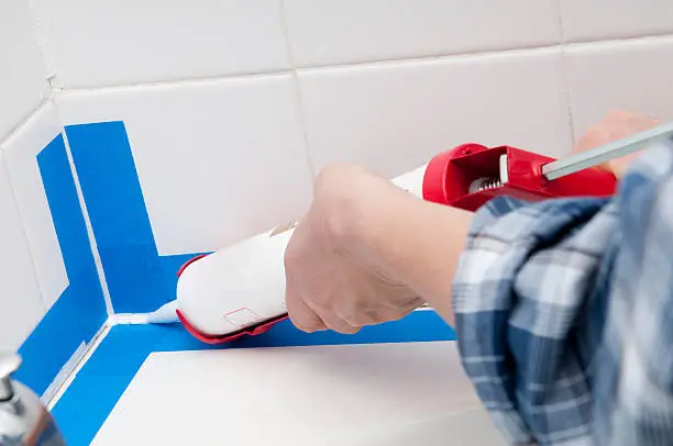 Caulking the bathroom tile.  Please see my portfolio for other home improvement images.