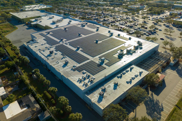 Electric photovoltaic solar panels installed on shopping mall building rooftop for production of green ecological electricity. Concept of producing sustainable energy Electric photovoltaic solar panels installed on shopping mall building rooftop for production of green ecological electricity. Concept of producing sustainable energy. solar panel manufacturing stock pictures, royalty-free photos & images